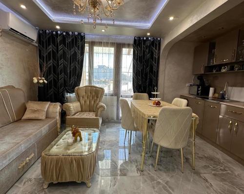 a living room with a couch and a table at AR Luxury VIP Apartments Ravda in Ravda