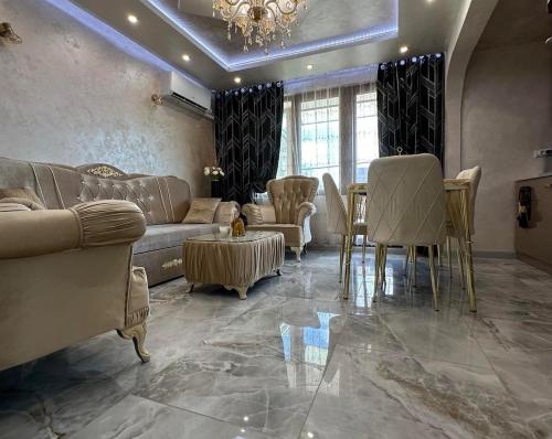 a living room with a couch and chairs and a table at AR Luxury VIP Apartments Ravda in Ravda