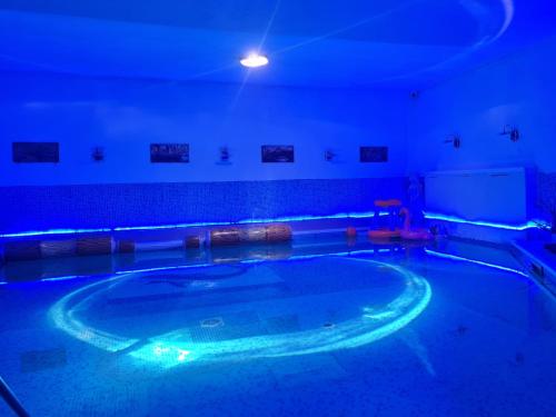a swimming pool with a blue lighting in a room at Hotel Dalia - Bankya in Bankya