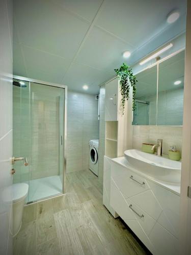 a bathroom with a sink and a toilet and a shower at VVVHouse in Manilva