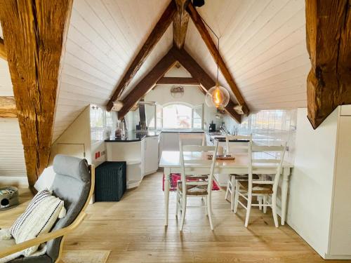 a kitchen and dining room with a table and chairs at Beautiful One Bedroom Atelier Near City Lucerne in Ruswil