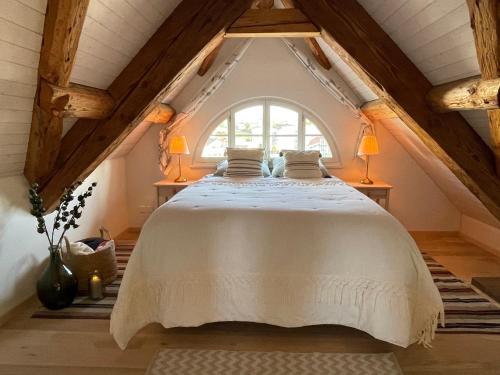 a bedroom with a large bed in a attic at Beautiful One Bedroom Atelier Near City Lucerne in Ruswil