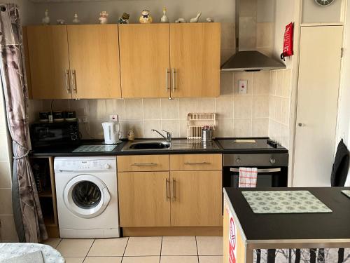 a kitchen with a sink and a washing machine at 1st Floor Hillview 2 bedroomed Central Location No pets in Brean