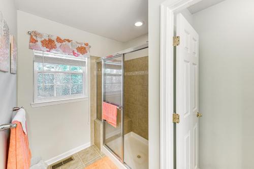 a bathroom with a shower and a glass door at Dog-Friendly Family Retreat Near Chincoteague Bay! in Greenbackville