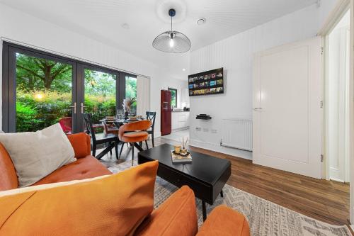 a living room with a couch and a table at Modern 2 Bedroom Apartment in Uxbridge London free parking in London