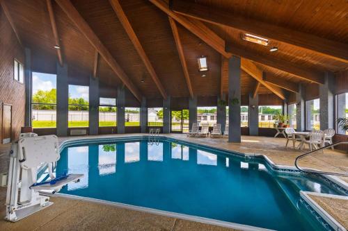 a large swimming pool in a building with a large ceiling at Days Inn by Wyndham Glasgow in Glasgow