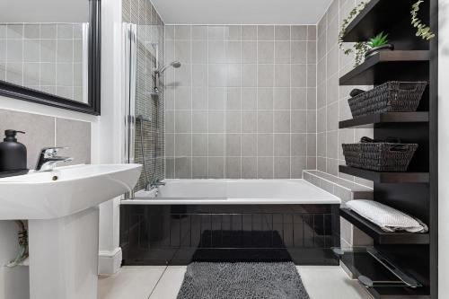 a bathroom with a sink and a bath tub at Modern 2 Bedroom Apartment in Uxbridge London free parking in London