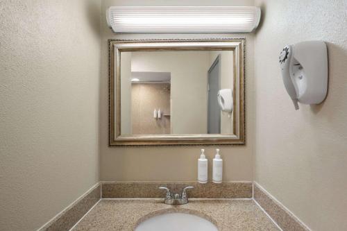 a bathroom with a sink and a mirror at Days Inn by Wyndham Klamath Falls in Klamath Falls