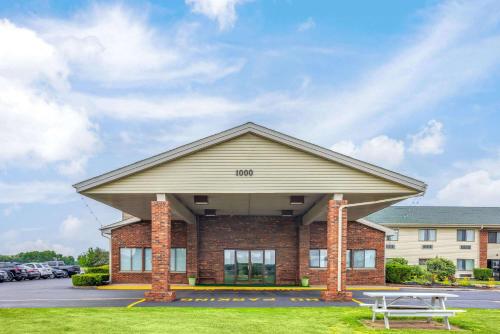 a building with a picnic table in front of it at Super 8 by Wyndham Henrietta/Rochester Area in Henrietta