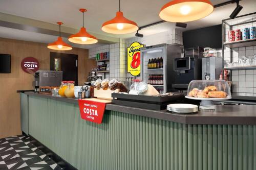 a fast food restaurant with a counter with food at Super 8 by Wyndham Durham in Durham