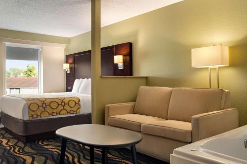 a hotel room with a bed and a couch at Baymont by Wyndham Georgetown Lexington North in Georgetown