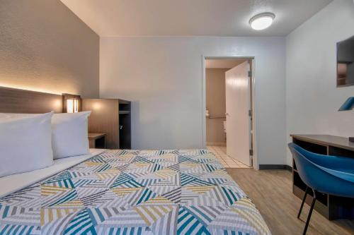 a hotel room with a bed and a desk at Motel 6-Albuquerque, NM - Midtown in Albuquerque
