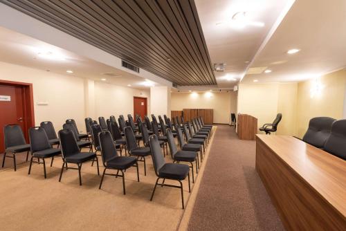 a conference room with chairs and a podium in it at Wyndham Cluj in Cluj-Napoca