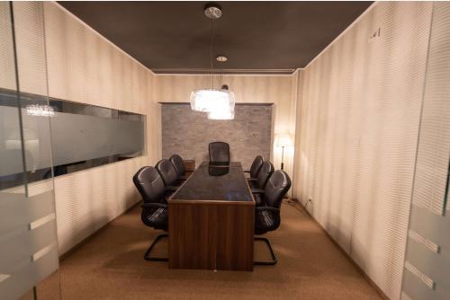 a conference room with a table and leather chairs at Wyndham Cluj in Cluj-Napoca