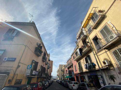 a city street with buildings and cars parked on the street at Casa Fraeli in Pozzuoli