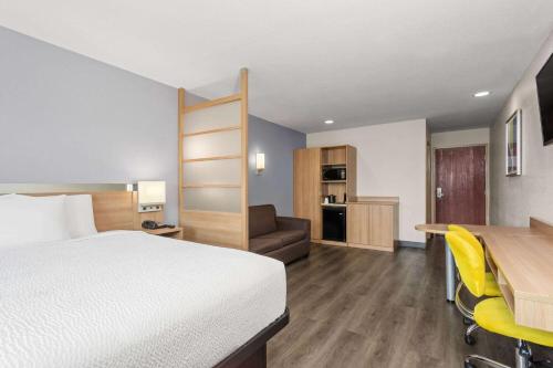 a hotel room with a bed and a desk at Microtel Inn & Suites by Wyndham Panama City in Panama City