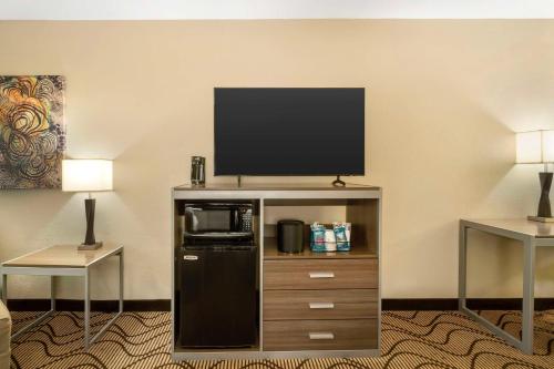 a room with a flat screen tv on top of a entertainment center at Best Western Heritage Inn Chico in Chico