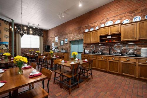 a restaurant with tables and chairs in a room at The Historic Brookstown Inn, Trademark Collection by Wyndham in Winston-Salem