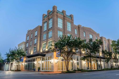 a large brick building on a street at TRYP by Wyndham Savannah in Savannah
