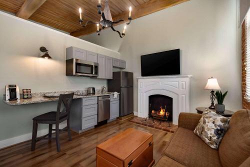 a living room with a couch and a fireplace at The Historic Brookstown Inn, Trademark Collection by Wyndham in Winston-Salem