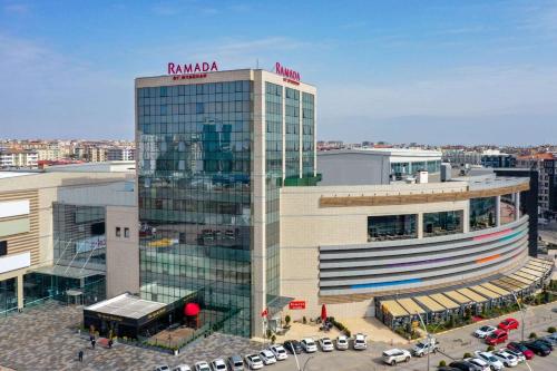a tall building with a sign on top of it at Ramada by Wyndham Diyarbakir in Diyarbakır