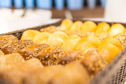 a bunch of pastries in a tray with sesame at Prize by Radisson, Hamburg City in Hamburg
