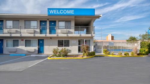 a building with a welcome sign on top of it at Studio 6 Albuquerque NM Midtown in Albuquerque