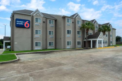 a building with a sign on the side of it at Studio 6 Suites Breaux Bridge, LA in Breaux Bridge
