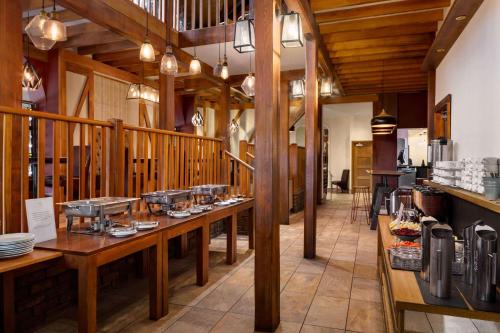 a restaurant with wooden floors and tables in a room at Heritage Park Pontypridd, Trademark Collection by Wyndham in Pontypridd