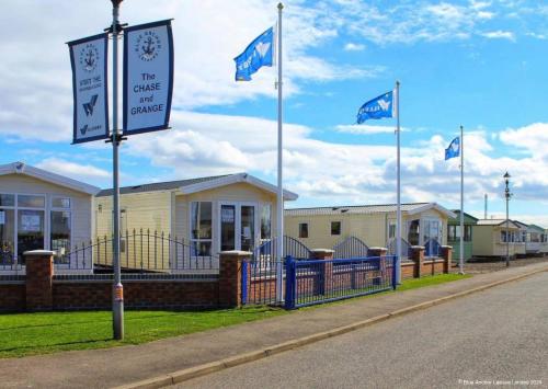 a street with flags in front of a building at The Chase Holiday Park in Ingoldmells