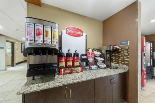 a coffee shop with a counter with drinks on it at Studio 6 Suites Breaux Bridge, LA in Breaux Bridge