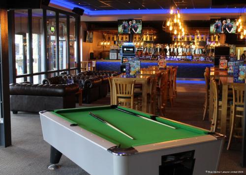 a pool table in a restaurant with a bar at The Chase Holiday Park in Ingoldmells