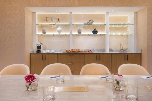 a conference room with a table and chairs at AZUR Legacy Collection Hotel in Vancouver