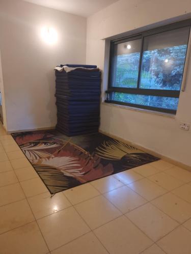 a room with a rug on the floor in front of a window at בית פרטי לחופש משפחתי in Bayit Wegan