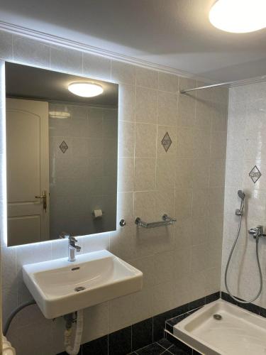 a bathroom with a sink and a mirror at Alyzia Apartment in Xylokastro