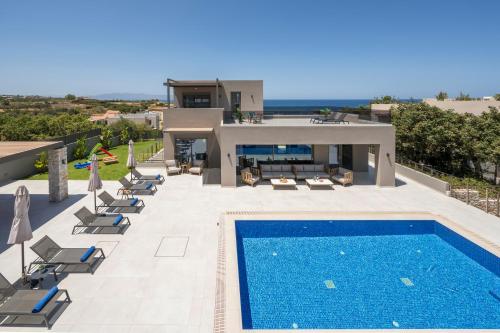 a villa with a swimming pool and a house at Imperium Luxury Villas-Sauna, Jacuzzi, Heated Pool & Gym-Chania in Kato Galatas