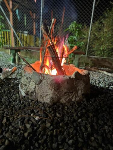 a fire pit in a yard with rocks at Finca Hotel Villa Mariana in Montenegro