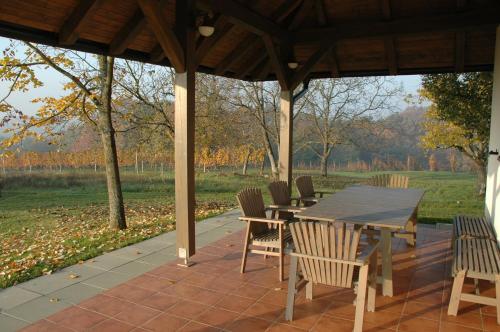 a wooden table and chairs on a patio at Country house Martinova Klet in Prosenjakovci