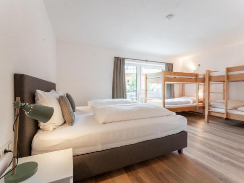 a bedroom with two bunk beds and a desk at Heimelig L in Saalbach-Hinterglemm