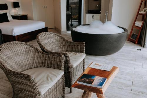 a living room with two chairs and a bath tub at Eagle View Escape in Rydal