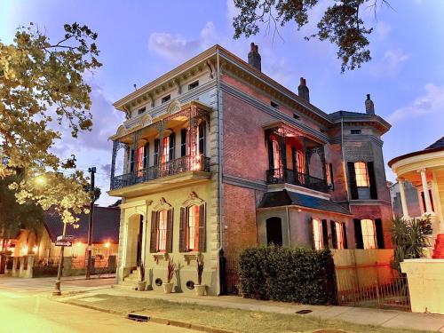 an old brick house on a city street at The Lanaux Mansion in New Orleans