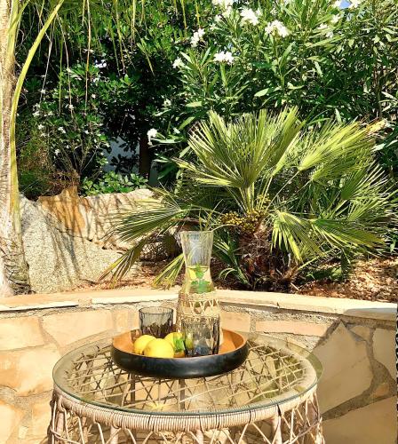 a glass vase and a bowl of fruit on a table at Villa Marlena, Calonge, Costa Brava,1 luxe private studio-appartement with private pool in quiet area, adults only, Catalonia, Spain in Calonge