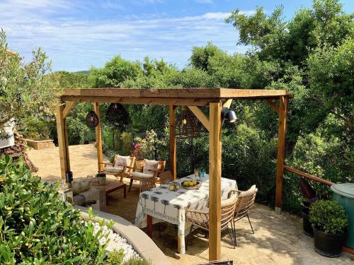a gazebo with a table and chairs in a yard at Villa Marlena, Calonge, Costa Brava,1 luxe private studio-appartement with private pool in quiet area, adults only, Catalonia, Spain in Calonge