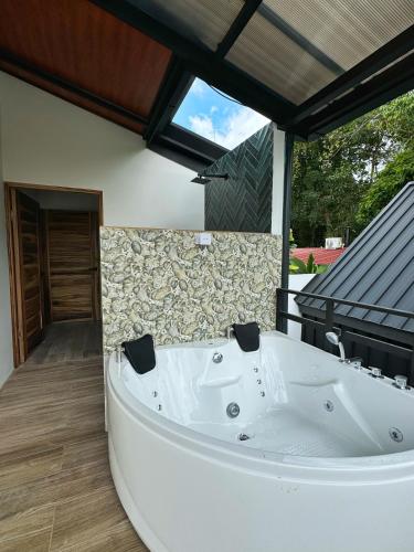 a large white bath tub sitting on a patio at Alma Vida Lofts in Fortuna