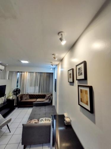 a living room with a couch and a table at Flat 203 Ed Clarice Lispector, Ilhotas- Rio Poty in Teresina