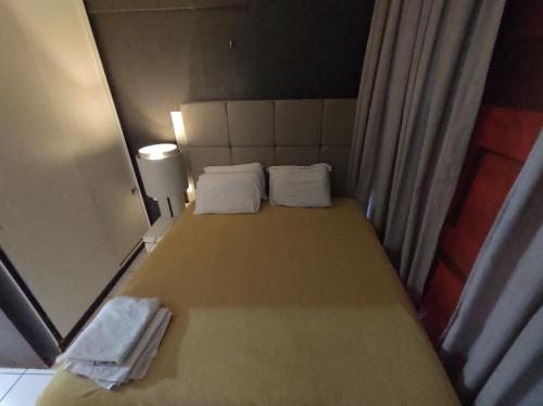 a bed with two white pillows in a room at Flat 203 Ed Clarice Lispector, Ilhotas- Rio Poty in Teresina