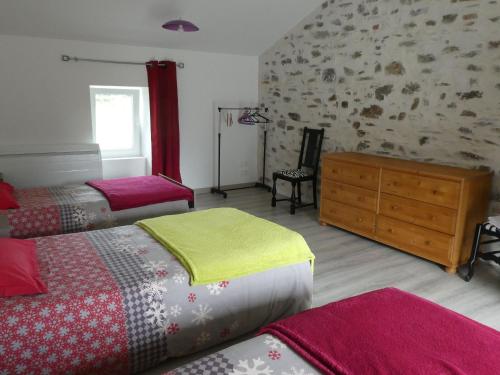 a bedroom with two beds and a wooden dresser at Maison rénovée en pleine campagne avec terrain, terrasse et équipements familiaux - FR-1-426-157 in La Roche-sur-Yon