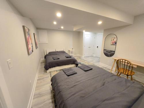 a bedroom with two beds and a mirror at Byward-Market Luxury GuestHouse in Ottawa