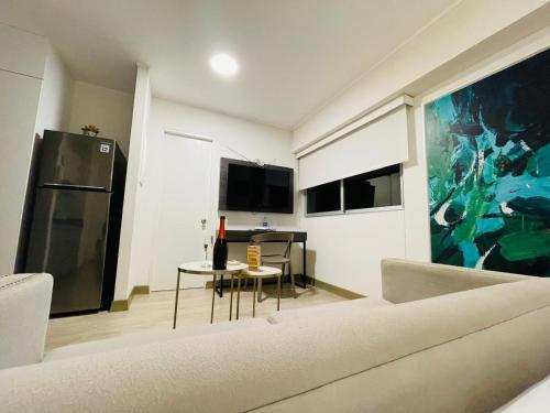 a living room with a couch and a table at Connect Studios by Vibrant in Lima