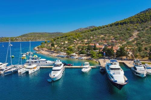 a group of boats are docked in a harbor at Rooms by the sea Cove Golubovac, Kornati - 23062 in Bizikovica